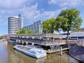 Moored tour boat near bicycle parking, Amsterdam, Netherlands